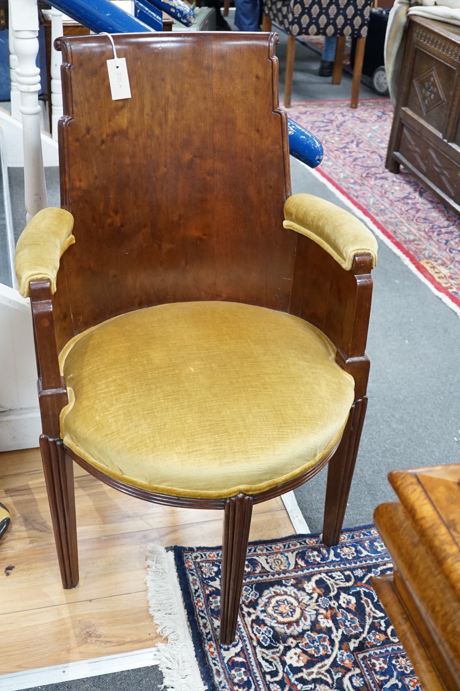 A stylish Art Deco mahogany elbow chair by Trollope and Son, numbered 4088, height 95cm *Please note the sale commences at 9am.